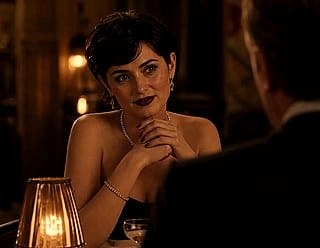 Woman listening to her dinner companion explain what he does for a living.'