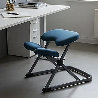 Ergonomic kneeling chair in front of office desk'