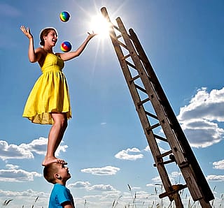 Ladder going to the sun and a Woman juggling rainbow-colored balls while balancing on A Boy's head?'