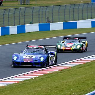 Photorealistic race cars racing'
